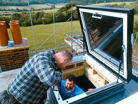 A access hatch rooflight being expertly installed